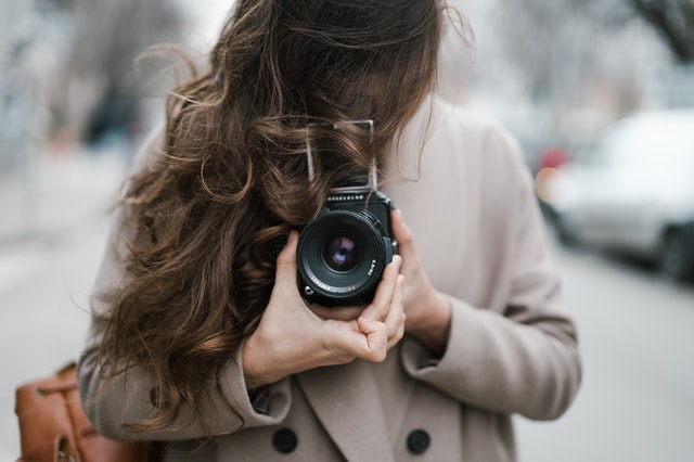 girl holding camera