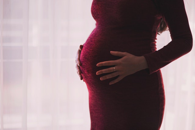 pregnant woman in purple dress